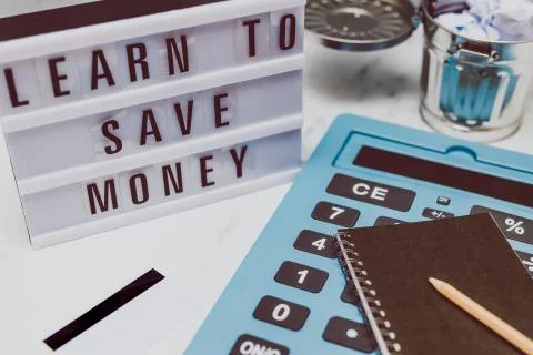 Lightbox with Learn to save money message next to payment card calculator and Stock Photos