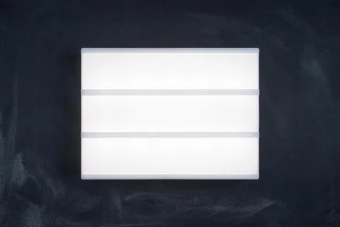 Lightbox luminous display without letters on the dark chalk board. Stock Photos