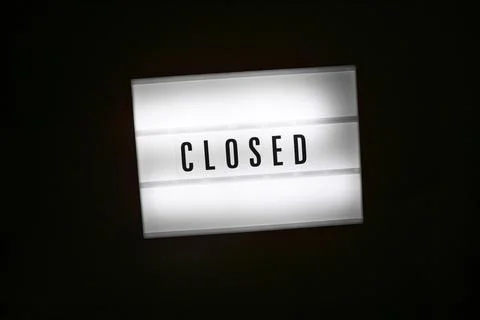 Lightbox with message CLOSED isolated on black background. Inscription in dark Stock Photos