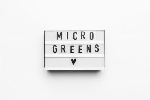 Lightbox with microgreens text on white background Stock Photos
