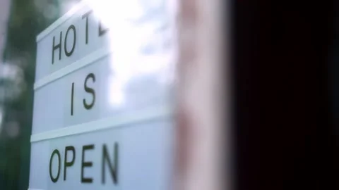 Lightbox with as sign HOTEL IS OPEN we are open again behind a glass door of the Stock Footage 132102121