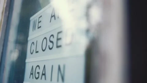 Lightbox with as sign We Are Closed Again we are open again behind a glass door Stock Footage 136417631
