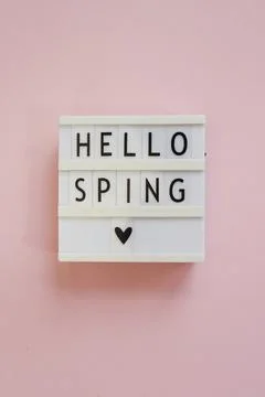 Lightbox with text Hello spring on pink background. Top view Flat lay Springt Stock Photos