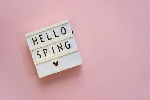 Lightbox with text Hello spring on pink background. Top view Flat lay Springt Stock Photos