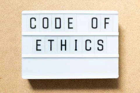 Lightbox with word code of ethics on wood background Stock Photos