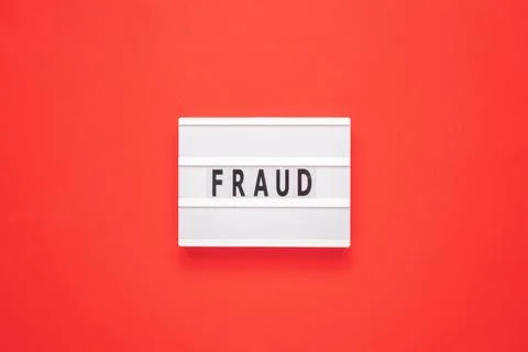 Lightbox with word fraud on red background. Business concept. Stock Photos