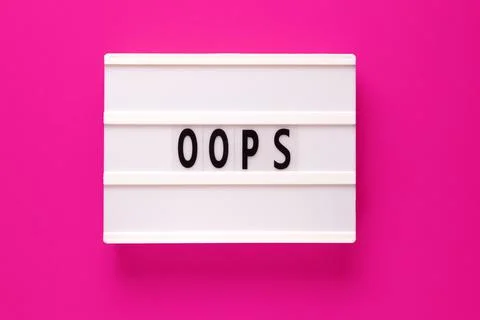 Lightbox with word oops on pink background. Stock Photos