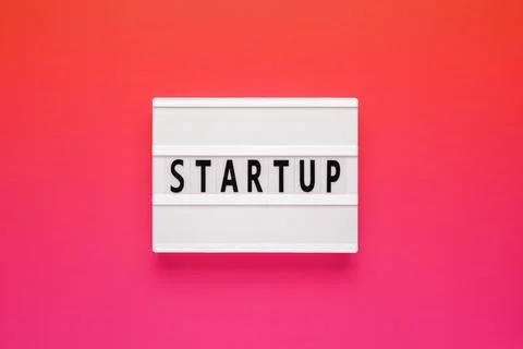 Lightbox with word startup on pink background. Business success or educationa Stock Photos