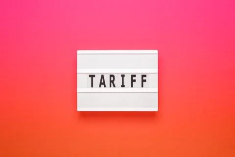 Lightbox with word tariff on pink gradient background. Stock Photos