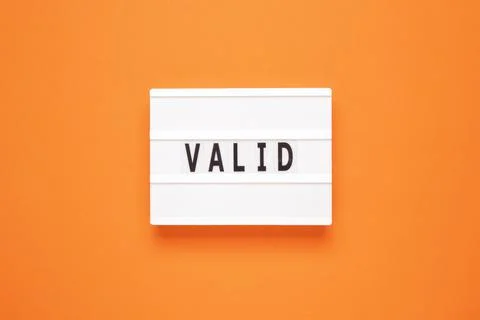 Lightbox with word valid on orange background Stock Photos