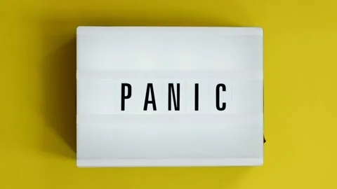 Lightbox with a words text Panic board on yellow background. Concept panic mood Stock Footage 143617638