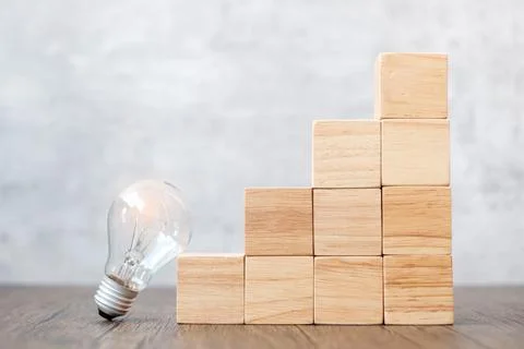 Lightbulb and wood block stack of building with business idea, creative, thin 스톡 사진