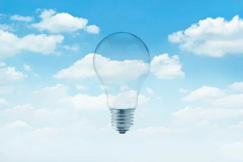 Lightbulb on blue sky with white clouds background Fotos de archivo
