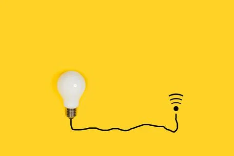 Lightbulb connected with a black line cable shape to a wi-fi sign Stock Photos