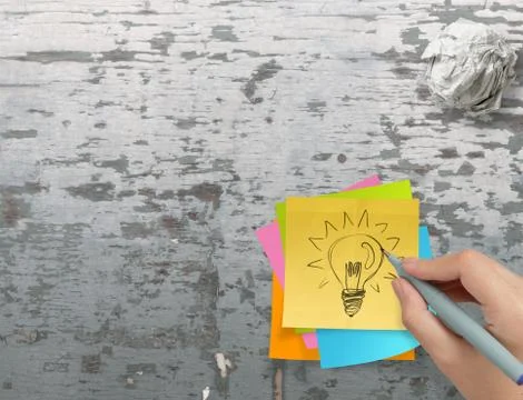 Lightbulb as creative on crumpled sticky note paper on texture desk as concep Иллюстрация