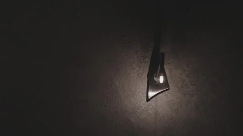 Lightbulb illuminating dark space casting warm glow Video stock 292394349