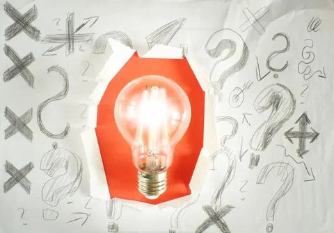 Lightbulb inside of punch paper with scribble and question marks,business Stock Photos