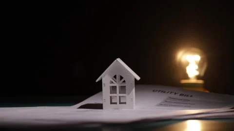 The lightbulb lights up with the utility bill and the house, electric recei.. Stock Footage 303215398
