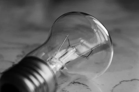 Lightbulb on a marble surface. Stock Photos
