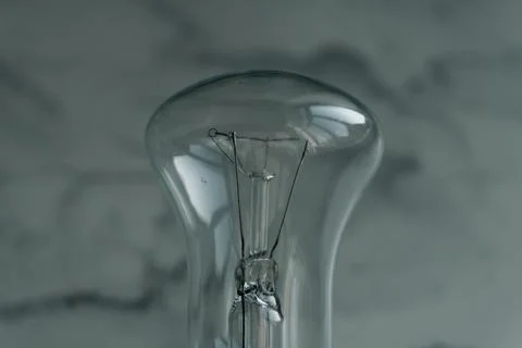Lightbulb on a marble surface. Stock Photos