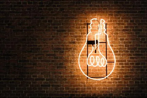 Lightbulb neon on the empty brick wall with copy space Stock Photos
