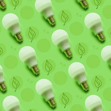Lightbulb pattern on a green background with drawn tree leaves. Energy-saving co Stock Photos
