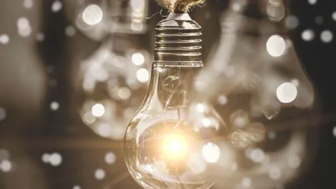 Lightbulb Slowly Lighting Up with Bokeh Effect Stock Footage 132003579