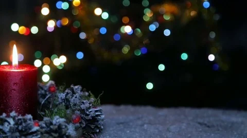 A lighted candle and a gift box on the background of a bokeh Stock Footage 82609194