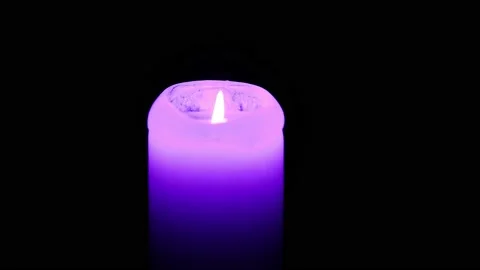A lighted candle burns in complete darkness. Candle flame movement. 4k Stock Footage 170380641