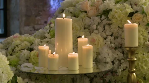 Lighted candles on backdrop of floral composition Video stock 44022094