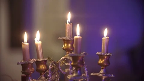 The lighted candles on beautiful candlesticks. Blurred background Stock-Footage 80922729