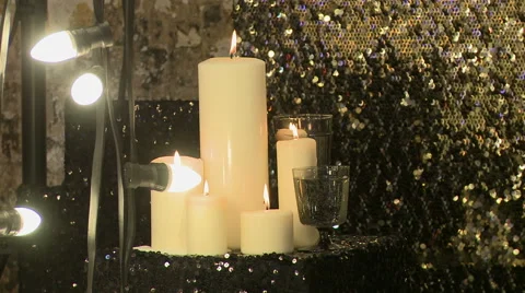 Lighted candles on draperies with sequins Stock Footage 44159078