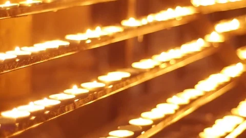Lighted candles on a gold background Stock Footage 74684322