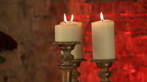 Lighted candles in golden candlesticks, close-up Stock Footage 44022795
