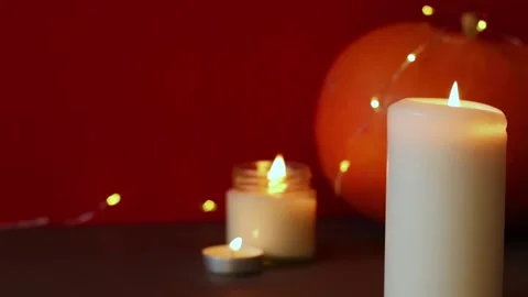 Lighted candles with pumpking on table. Halloween atmosphere, decoration Stock Footage 142403652