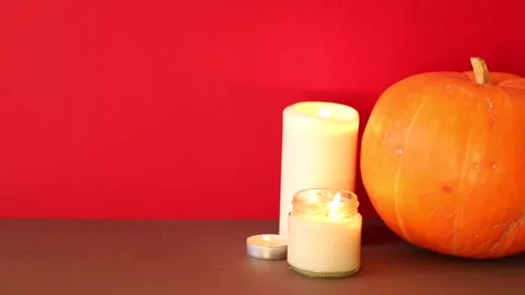 Lighted candles with pumpking on table. Halloween atmosphere, decoration Vídeo Stock 143564059