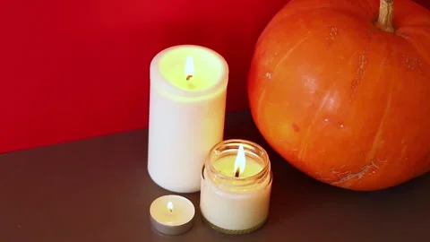 Lighted candles with pumpking on table. Halloween atmosphere, decoration Stock Footage 143564102
