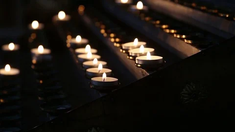Lighted candles in the temple in the twilight. Burning church candles Video stock 103235426