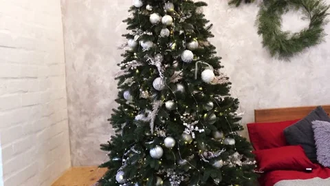 Lighted Christmas tree with presents underneath in living room Stock Footage 144997694