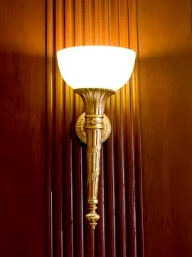 Lighted classic sconce on the wall Stock Photos