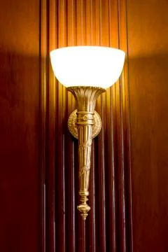Lighted classic sconce on the wall Stock Photos