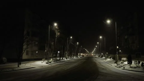 Lighted intersection in the city on a snowy winter night Video stock 147357082