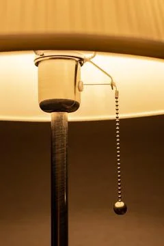 Lighted lamp standing in the dark on the background of the wall Stock Photos