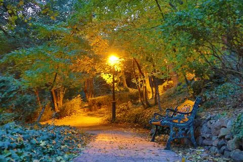 Lighted lantern and bench in the park Stock Photos