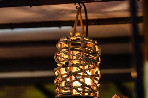 A lighted lantern hanging from a rope Stock Photos