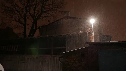 Lighted lantern at night and snow falls in winter. 4K UHD Stock Footage 73190571