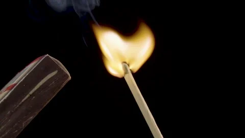 A lighted match on a black background. Hold a lighted match. The fire Stock Footage 143560731