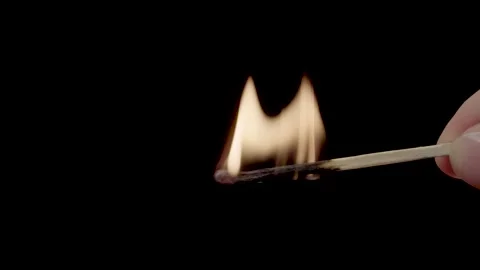 A lighted match on a black background. Hold a lighted match. Stock Footage 143560791