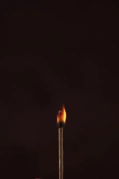 A lighted match on a dark background Foto stock
