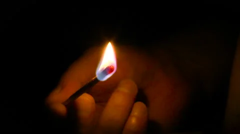Lighted match in hand on a black background Stock Footage 68350039